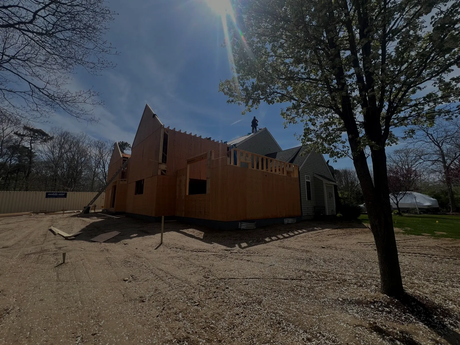 A new home under construction at dusk, framing and sheathing complete